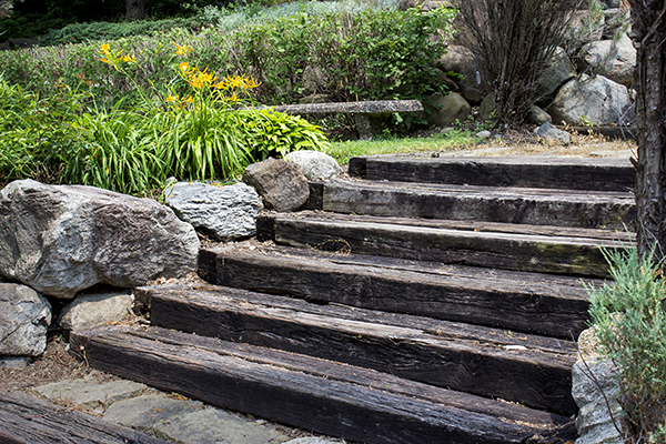 Wooden stairs with boulders and golden flowers